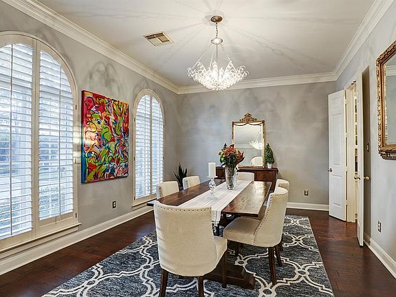 As you walk in the front door you have a charming formal dining room with custom shutters and an abundance of natural light.