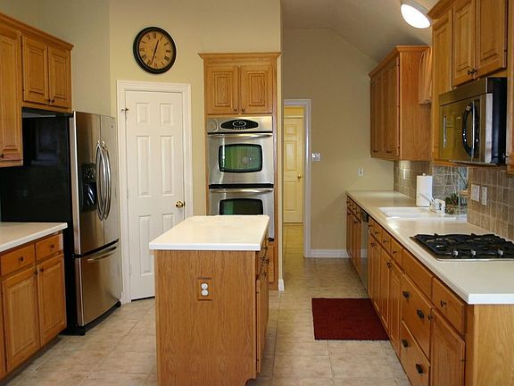Kitchen with stainless appliances including double oven