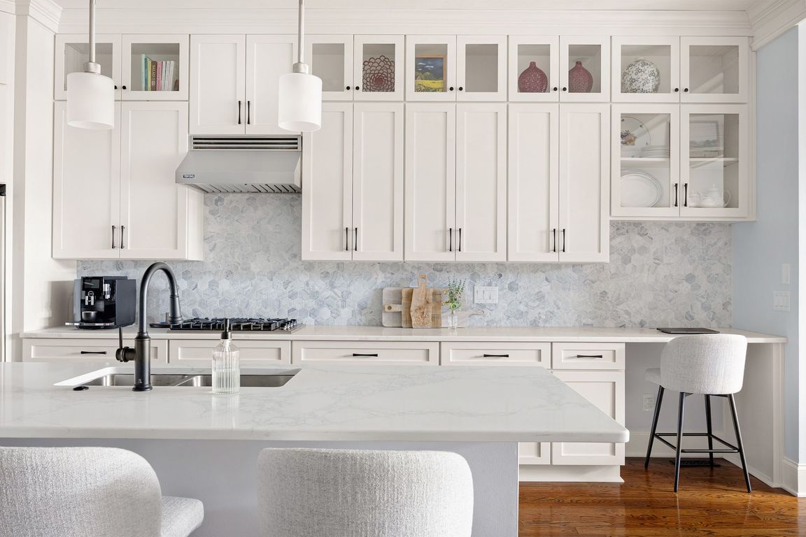 Kitchen - quartz countertops, stainless steel appliances, viking, marble octagonal tile backsplash, hardwood floors, crown molding, ten foot ceilings, custom built-ins, custom moldings, fireplace