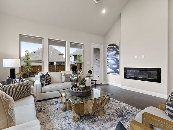 REPRESENTATIVE PHOTO - Living room in the Plaza home plan by Trophy Signature Homes