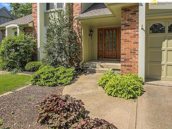 Impressive leaded glass front doors and covered portico.