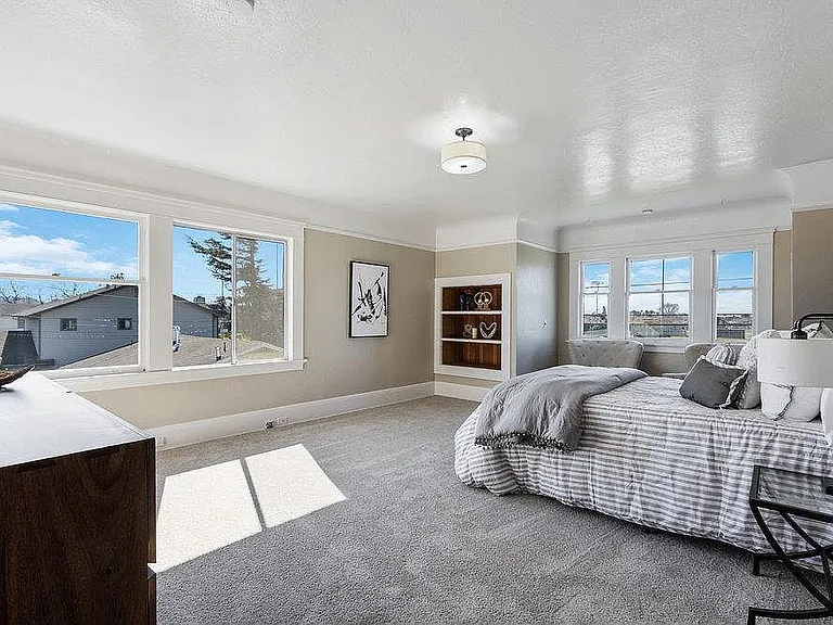Master bedroom- this is now painted a deep sage green and has blackout shades (the sun rises right through that window on the left)