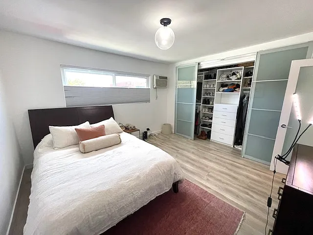 Large bedroom with lots of closet space. Queen sized bed in pic