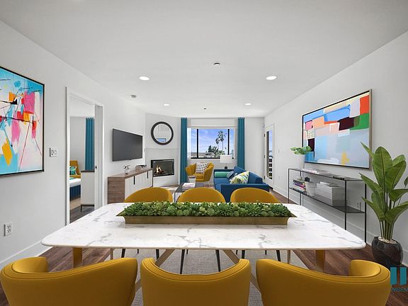 Open-Concept Dining and Living Room with Fireplace and Patio