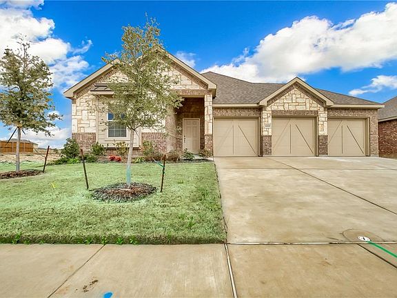 Notice the brick & stone elevation and 3 gar garage.