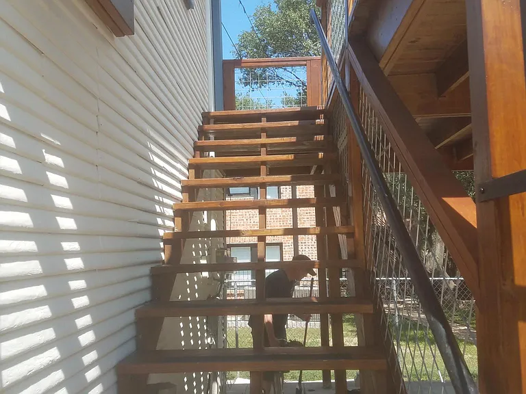 Enter Apartment via stairs behind security gate.