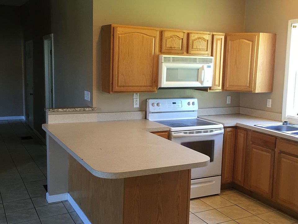 Kitchen from rear entrance, Large peninsula, Range, Microwav