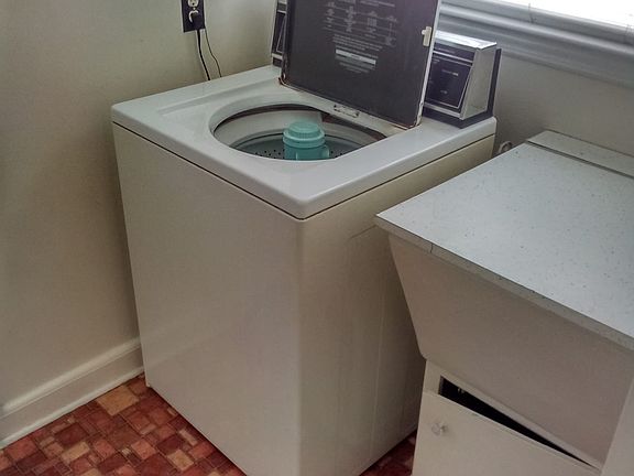 Near back door...washing machine and wash basin off kitchen.