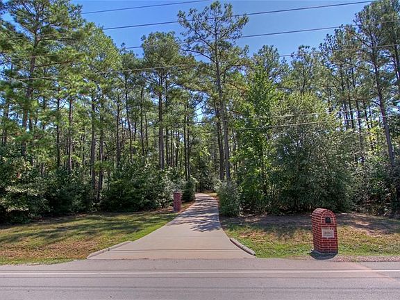 You can't see the home behind all the trees from the road in front.