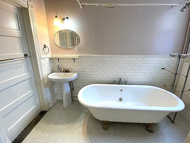 Lovely bathroom include this vintage French claw-foot bathtub..