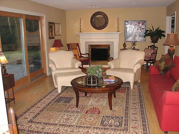 The living room boasts a fireplace and oversized sliders to the patio