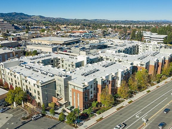 Aerial view of building exterior and views.