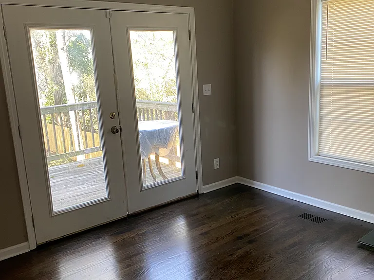 Dining area on first floor with doors that leads to to deck.