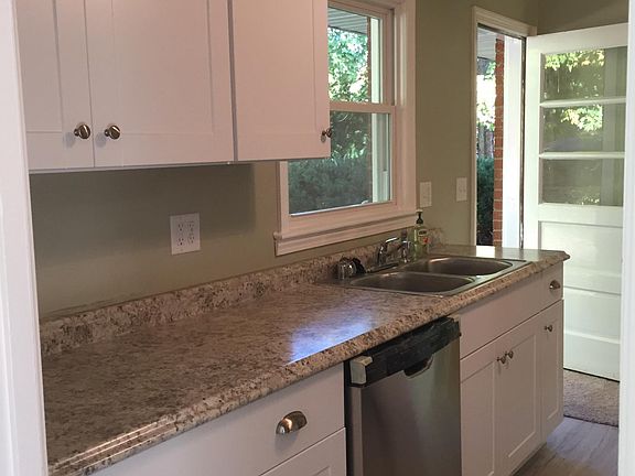 White kitchen with great counter space & door to outside