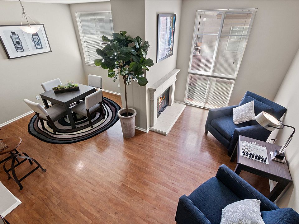 Chic living area with elegant dining, cozy fireplace, and bright natural light.
