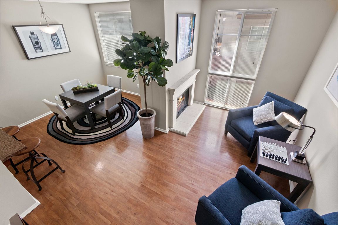 Chic living area with elegant dining, cozy fireplace, and bright natural light.