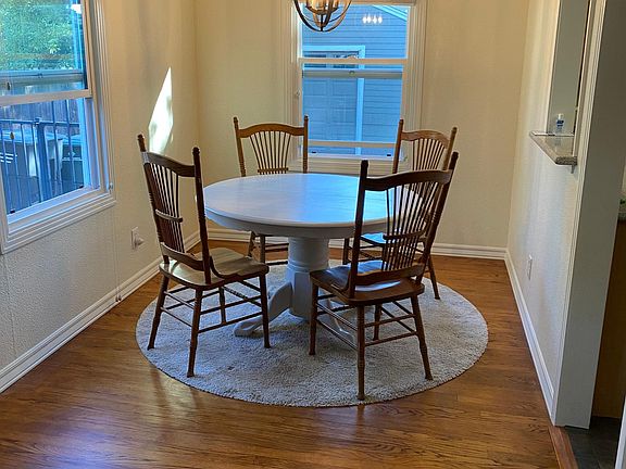 Dining room has lots of windows and pendent light