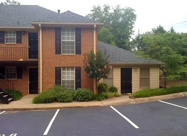 Lower black door_.brick building