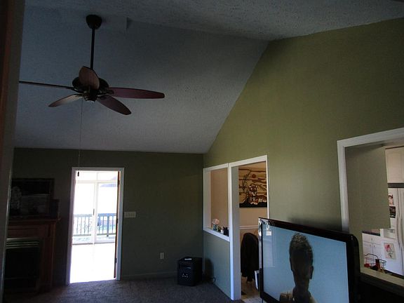 Family room vaulted with ceiling fan