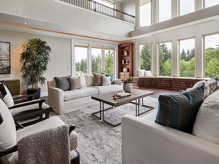 Living room with view of golf course through the windows shown