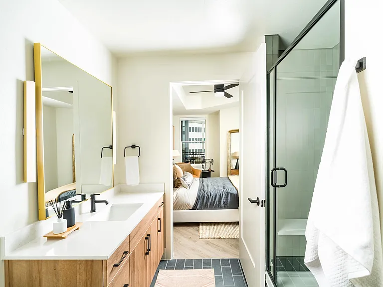 Bright and airy baths at Modera St. Paul feature sleek finishes and spacious layouts, seamlessly connecting to your restful bedroom retreat in Dallas.