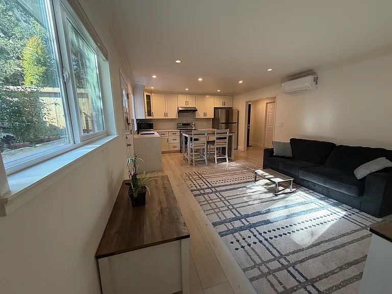 Full view of living room, dining area, and kitchen.