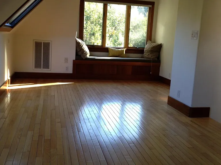 Upstairs bedroom with window seat looking at creek
