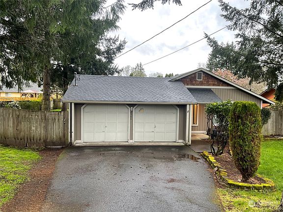 Two car attached garage with man door out to the side yard.>