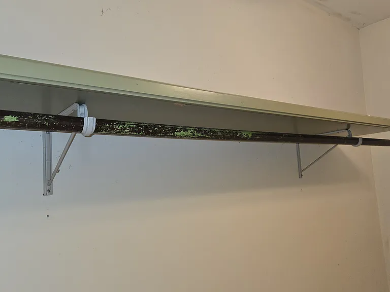 Shelf and closet Rack in Laundry Room