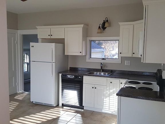 Spacious, light-filled kitchen with modern appliances and cabinetry.