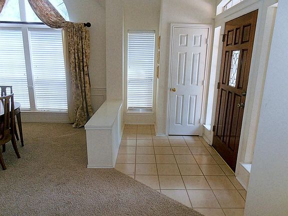 Foyer with tile floors and guest closet.