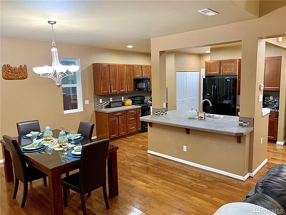 Amazing Open Floor Plan that allows you to see every part of the house. From the Fireplace looking into the kitchen and dining room area.  