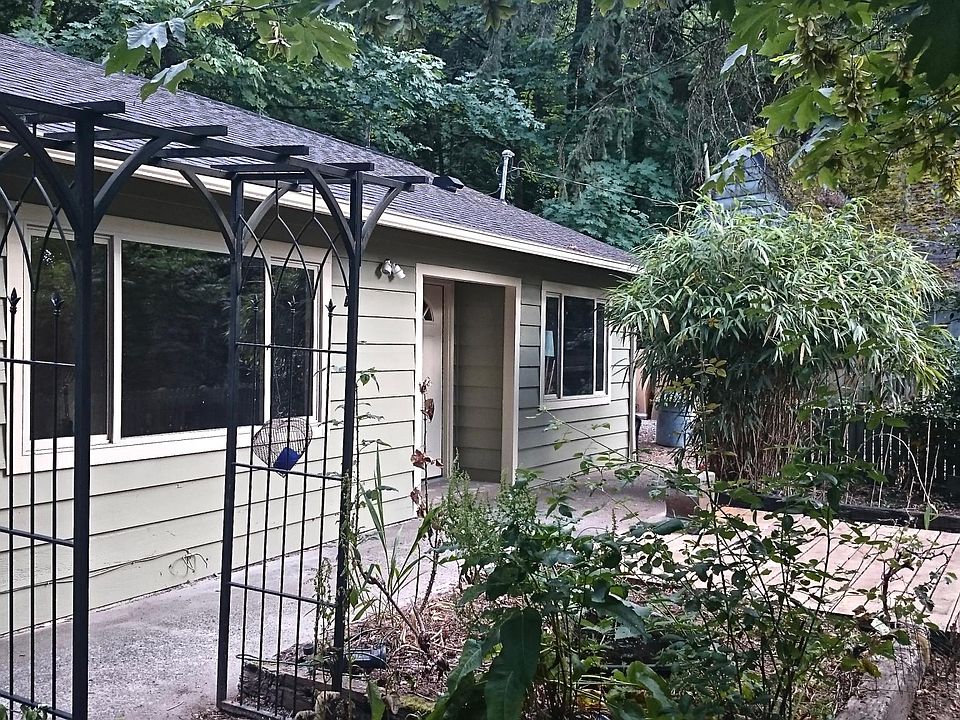Front yard with Deck and private wooded setting.