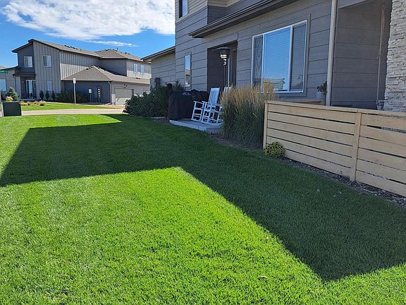 End unit side patio and lawn area