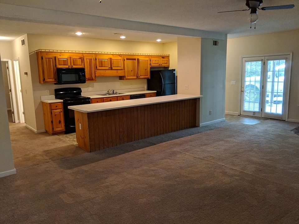 Large kitchen, dining, and living room area with plenty of cabinets and a pantry