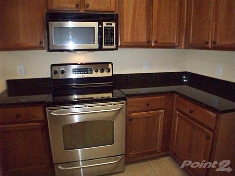 Gorgeous cabinetry, granite counter tops, tile floors and stainless steel appliances round out this 