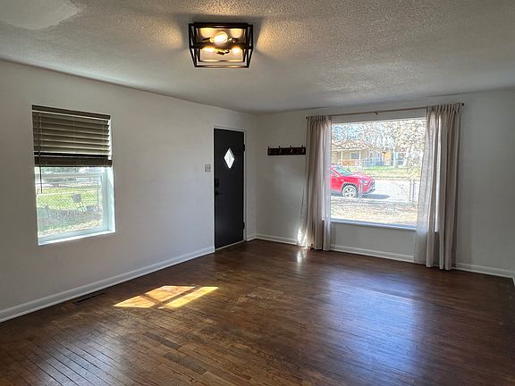 Living room with hardwood floors and fresh paint throughout the entire interior