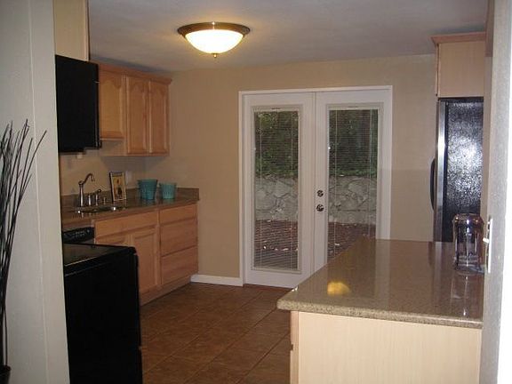 Totally remodeled kitchen with maple cabinets and granite slab counters
