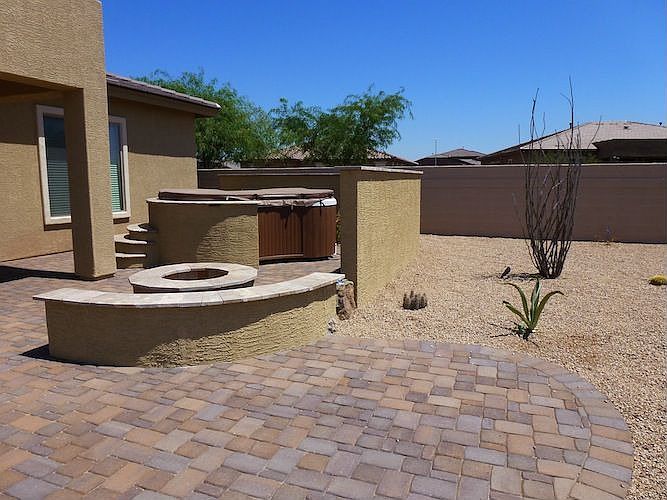 Patio, spa surround and privacy stucco and stone wall.