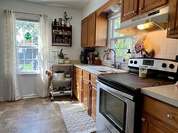 Nice Oak Kitchen with stove and refrigerator.