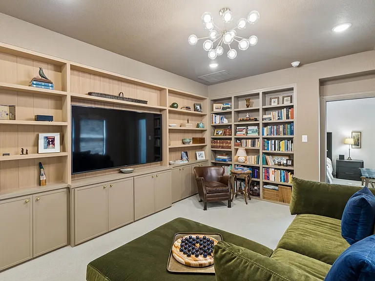 Library off primary bedroom with smart TV.