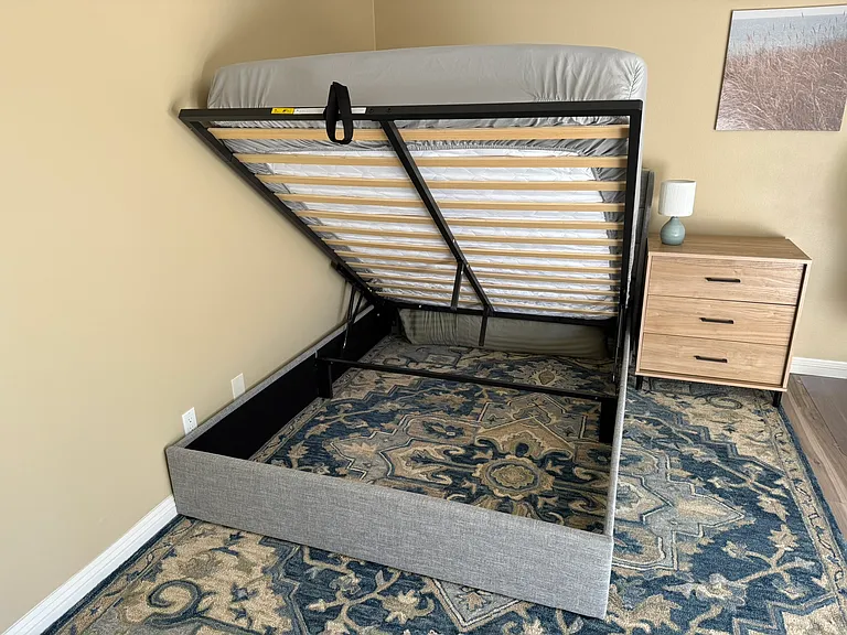 Extra storage space under bed. Light on dresser next to bed is a touch-light