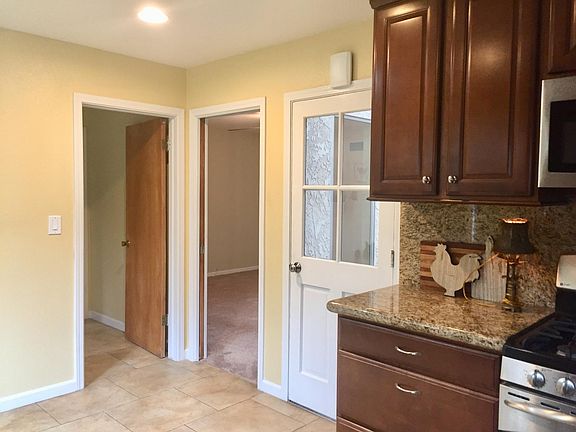 Kitchen looking into bonus room and laundry
