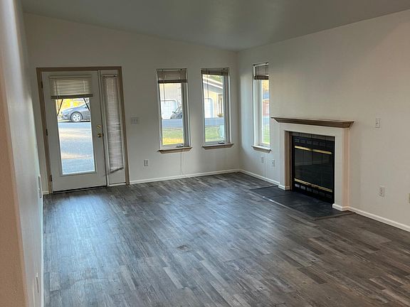 Bright and spacious entry and living room. New flooring and paint throughout.