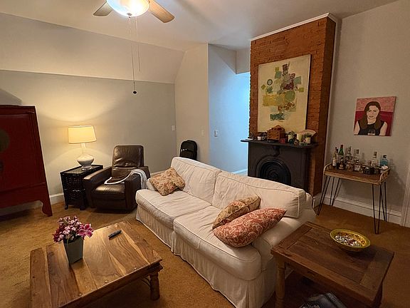 Living room with decorative fireplace.
Very comfortable couch and chairs. Fully carpeted.