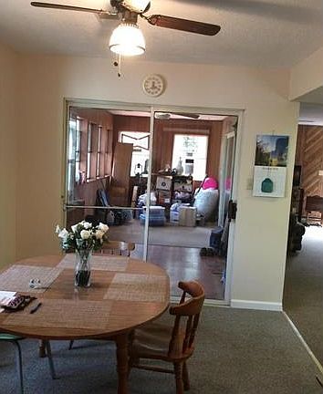 Dining area with view to enclosed porch with sliding glass door