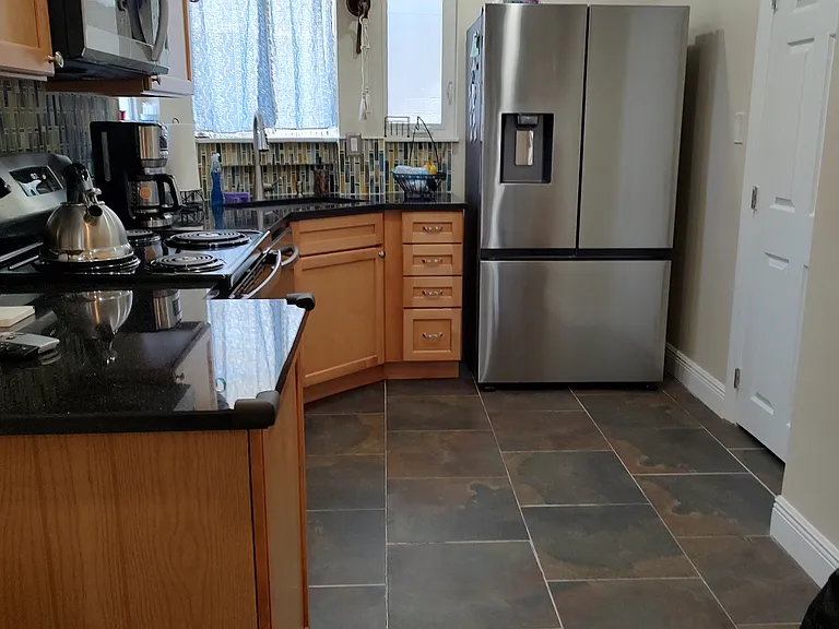 Full kitchen with stainless steel appliances including refrigerator, microwave, stove, dishwasher, and garbage disposal.