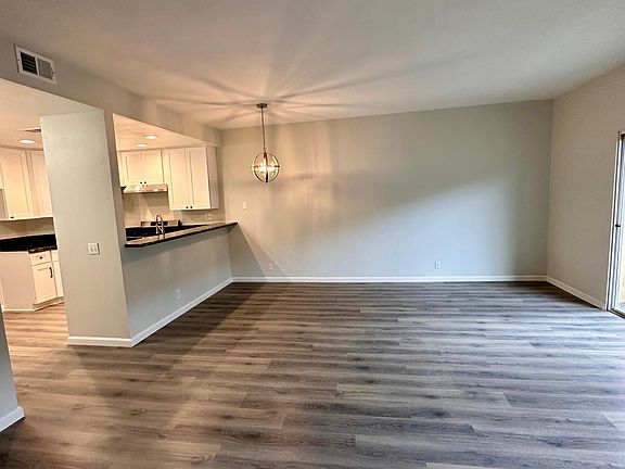 View from living room and bedroom area of kitchen and dining area