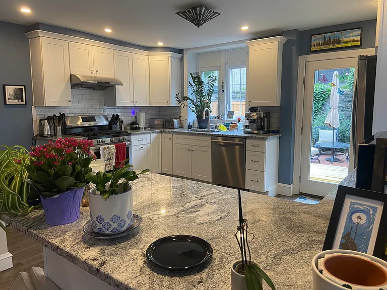 Bright kitchen with range hood, gas range, quiet dishwasher and fridge with ice dispense