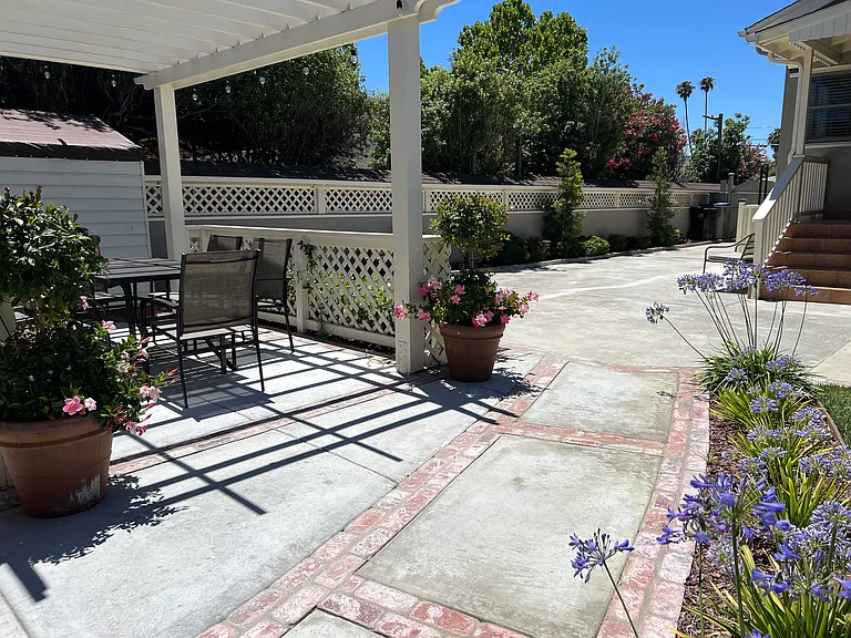 Outdoor lighted pergola with dining table